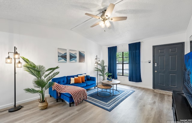9630 NW Simplicity Dr, San Antonio, TX 78245 - living room featuring wood finished floors, vaulted ceiling, a textured ceiling, baseboards, and ceiling fan