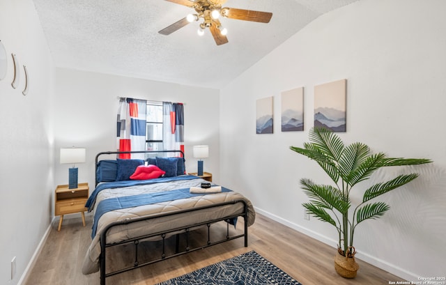9630 NW Simplicity Dr, San Antonio, TX 78245 - bedroom with vaulted ceiling, baseboards, wood finished floors, a textured ceiling, and a ceiling fan