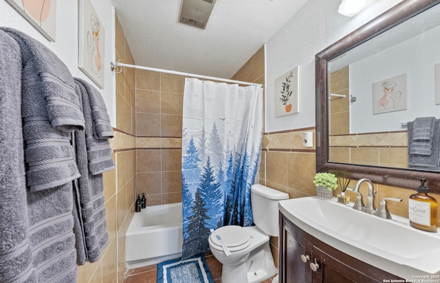 9630 NW Simplicity Dr, San Antonio, TX 78245 - bathroom with vanity, tile walls, shower / bath combination with curtain, toilet, and a textured ceiling