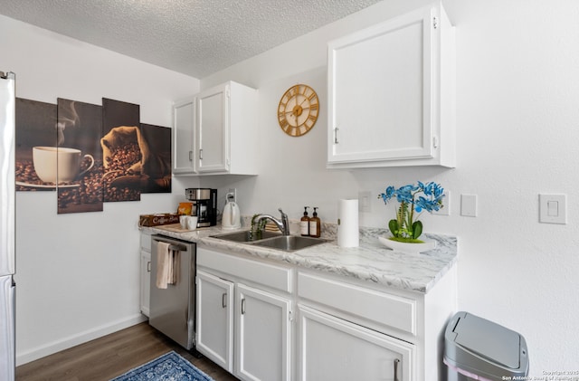 9630 NW Simplicity Dr, San Antonio, TX 78245 - kitchen with dishwasher, a sink, dark wood finished floors, light countertops, and white cabinets