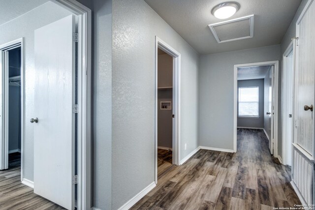 510 Hampton Cv, Boerne, TX 78006 - hallway with attic access, wood finished floors, baseboards, and a textured wall