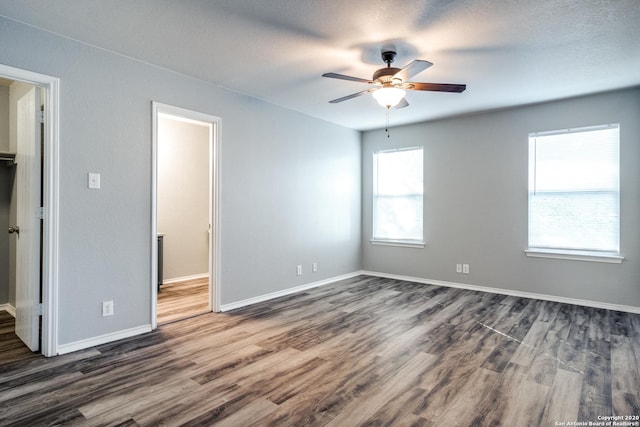 510 Hampton Cv, Boerne, TX 78006 - empty room with ceiling fan, dark wood finished floors, and baseboards