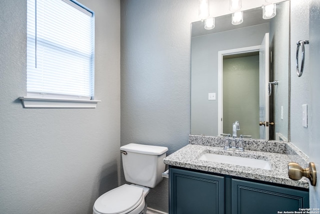 510 Hampton Cv, Boerne, TX 78006 - bathroom featuring toilet, healthy amount of natural light, vanity, and a textured wall