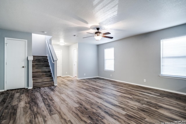 510 Hampton Cv, Boerne, TX 78006 - unfurnished living room with ceiling fan, dark wood-style floors, stairway, a textured ceiling, and baseboards