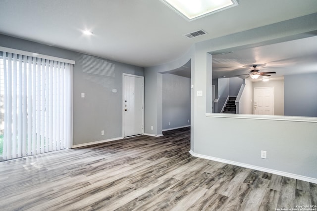 510 Hampton Cv, Boerne, TX 78006 - unfurnished living room with wood finished floors, baseboards, plenty of natural light, and stairway