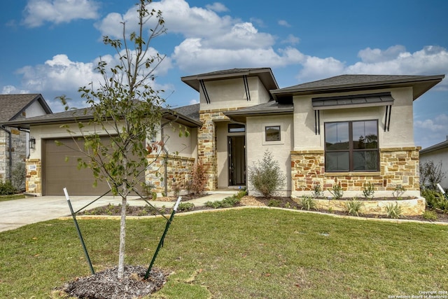 23350 Grande Vis, San Antonio, TX 78261 - prairie-style home with stone siding, concrete driveway, stucco siding, a garage, and a front lawn