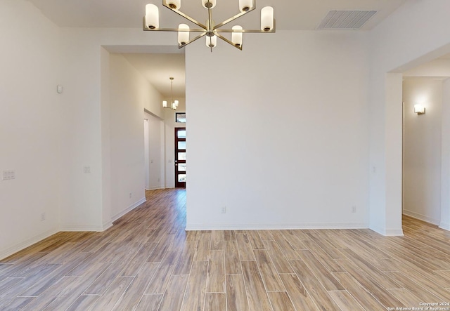 23350 Grande Vis, San Antonio, TX 78261 - unfurnished room with a chandelier, light wood-type flooring, and baseboards