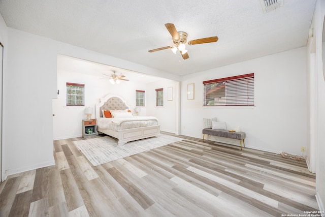 7035 Forest Mdw, San Antonio, TX 78240 - bedroom with wood finished floors, ceiling fan, baseboards, and a textured ceiling