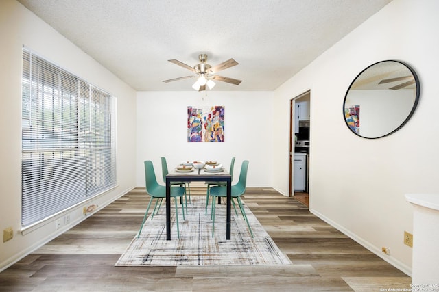 7035 Forest Mdw, San Antonio, TX 78240 - dining space featuring ceiling fan, wood finished floors, a textured ceiling, and baseboards