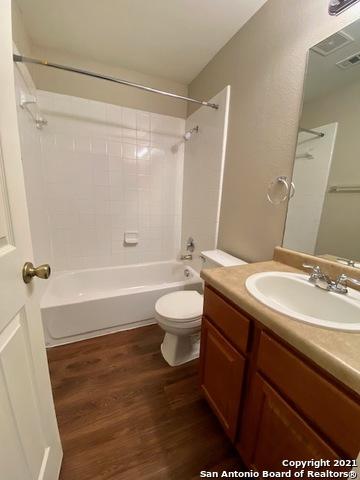6926 Lunar Way, San Antonio, TX 78109 - full bath featuring wood finished floors, bathtub / shower combination, vanity, and toilet