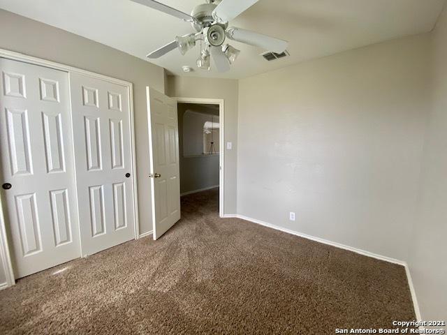 6926 Lunar Way, San Antonio, TX 78109 - unfurnished bedroom with carpet floors, baseboards, a closet, and ceiling fan
