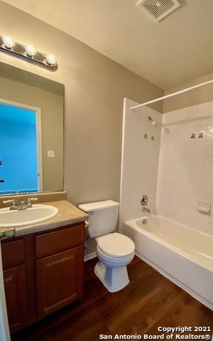 6926 Lunar Way, San Antonio, TX 78109 - bathroom featuring toilet, wood finished floors, vanity, and tub / shower combination