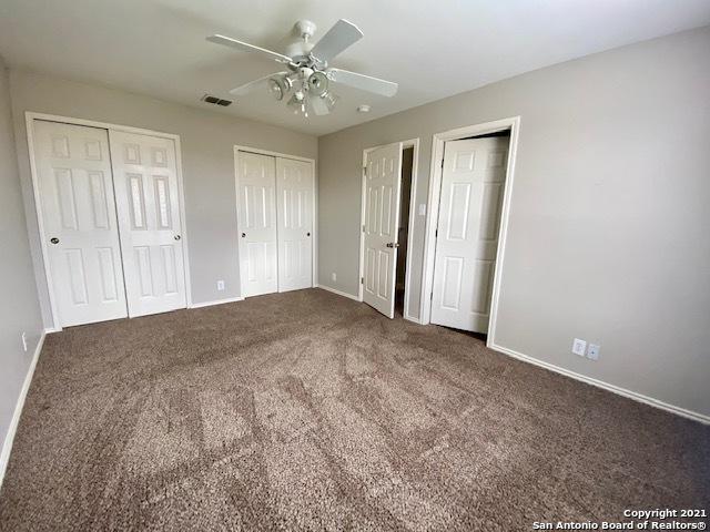 6926 Lunar Way, San Antonio, TX 78109 - unfurnished bedroom with two closets, baseboards, carpet floors, and a ceiling fan