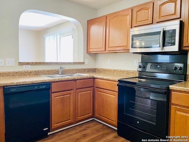 6926 Lunar Way, San Antonio, TX 78109 - kitchen featuring black appliances, a sink, dark wood finished floors, and light countertops