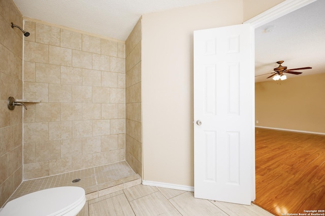 3702 Candlebluff, San Antonio, TX 78244 - bathroom with tiled shower, ceiling fan, baseboards, toilet, and wood finished floors