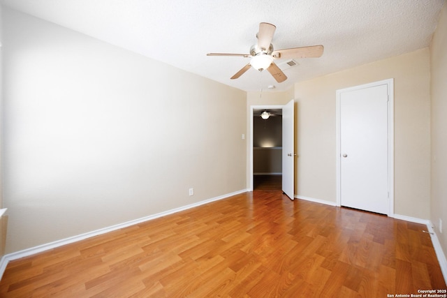 3702 Candlebluff, San Antonio, TX 78244 - unfurnished bedroom featuring light wood finished floors, baseboards, and a ceiling fan
