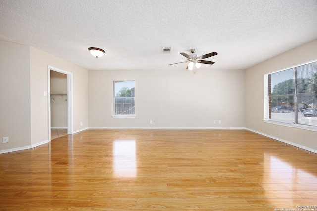 3702 Candlebluff, San Antonio, TX 78244 - spare room with a ceiling fan, healthy amount of natural light, light wood-style flooring, and a textured ceiling