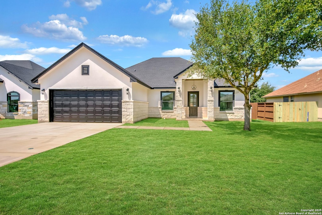 15613 Fox Ln, Selma, TX 78154 - view of front of home featuring stucco siding, stone siding, concrete driveway, and a garage