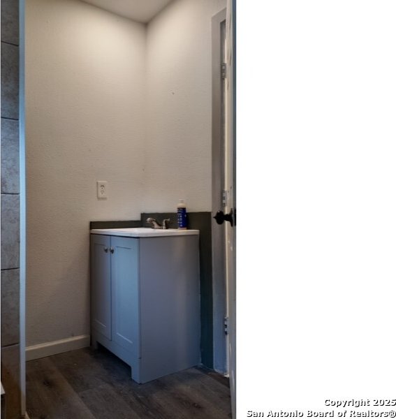 1414 Rivas, San Antonio, TX 78207 - bathroom with wood finished floors and vanity