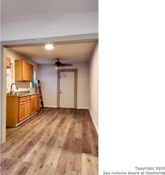 1414 Rivas, San Antonio, TX 78207 - kitchen featuring light wood-style flooring, a ceiling fan, baseboards, and a sink