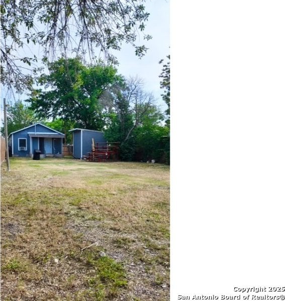 1414 Rivas, San Antonio, TX 78207 - view of grassy yard featuring an outdoor structure