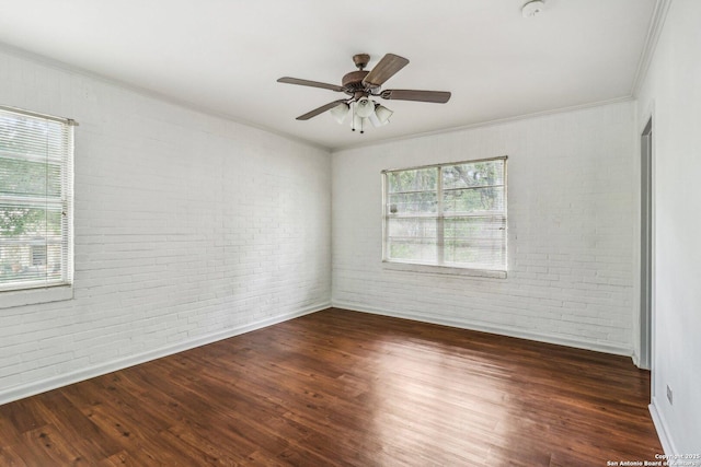 7735 Mocking Bird Ln, San Antonio, TX 78229 - unfurnished room with crown molding, brick wall, wood finished floors, baseboards, and ceiling fan