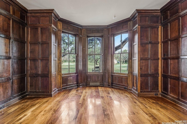7735 Mocking Bird Ln, San Antonio, TX 78229 - spare room featuring wood-type flooring and wood walls