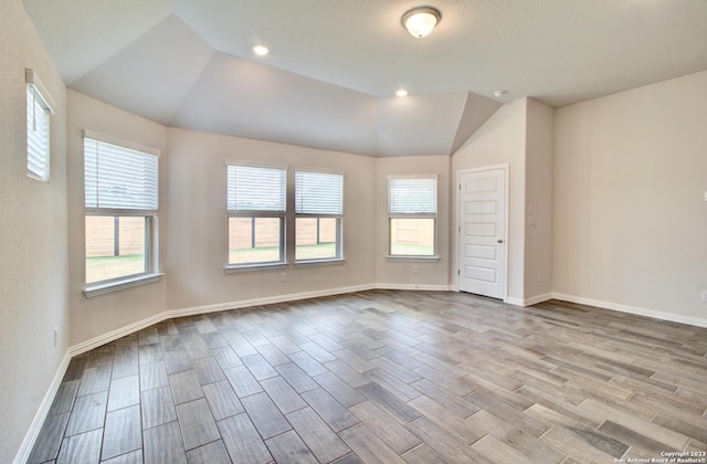 2035 Stephanie Ave, New Braunfels, TX 78132 - spare room featuring wood tiled floors, vaulted ceiling, and baseboards