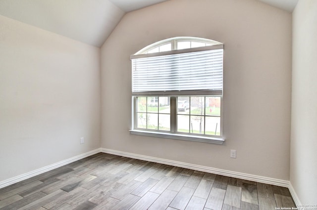 2035 Stephanie Ave, New Braunfels, TX 78132 - spare room with lofted ceiling, wood finished floors, and baseboards