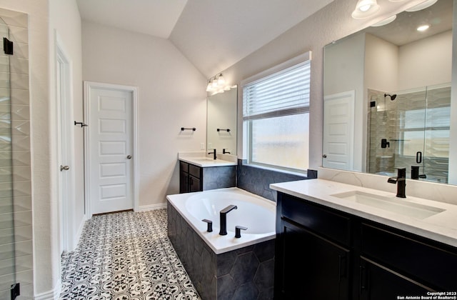 2035 Stephanie Ave, New Braunfels, TX 78132 - bathroom with a stall shower, two vanities, a garden tub, lofted ceiling, and tile patterned floors