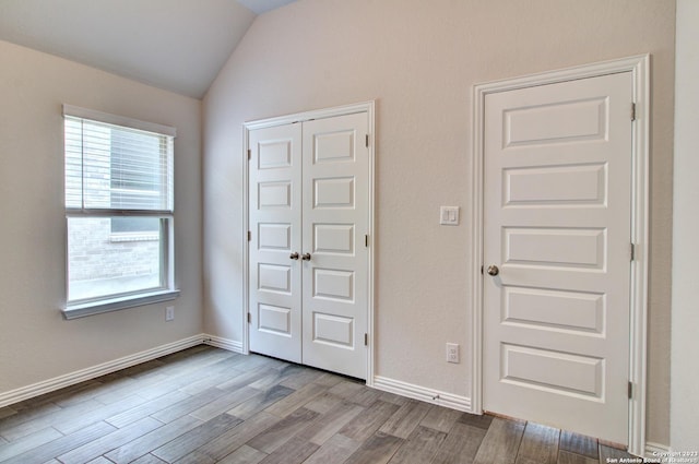 2035 Stephanie Ave, New Braunfels, TX 78132 - unfurnished bedroom with lofted ceiling, wood finished floors, a closet, and baseboards
