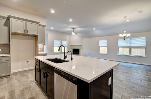 2035 Stephanie Ave, New Braunfels, TX 78132 - kitchen featuring stainless steel dishwasher, a sink, ceiling fan, open floor plan, and a fireplace