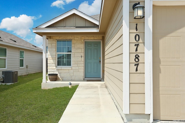 10787 Giacconi, Converse, TX 78109 - view of exterior entry with central AC unit, a yard, and board and batten siding
