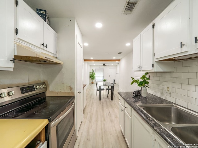 11105 Lone Shadow, Live Oak, TX 78233 - kitchen featuring stainless steel electric stove, light wood finished floors, white cabinetry, backsplash, and under cabinet range hood