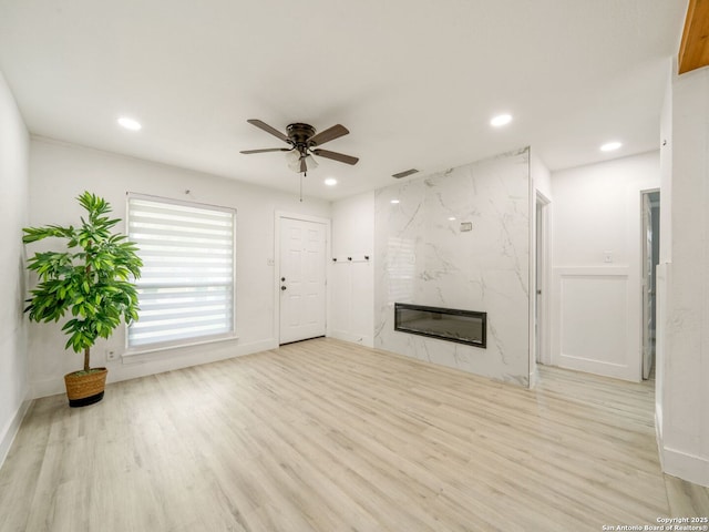 11105 Lone Shadow, Live Oak, TX 78233 - unfurnished living room with ceiling fan, wood finished floors, a high end fireplace, recessed lighting, and baseboards