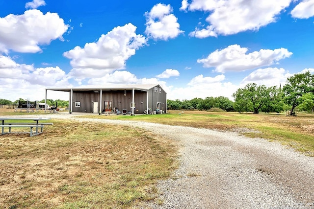 757 Joy, Floresville, TX 78114 - view of pole building with curved driveway and a yard