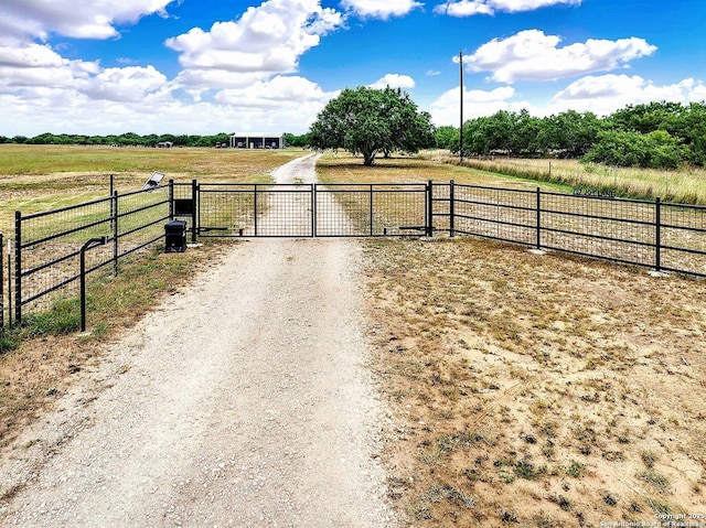 757 Joy, Floresville, TX 78114 - view of dirt / gravel road featuring a view of countryside, a gate, and a gated entry