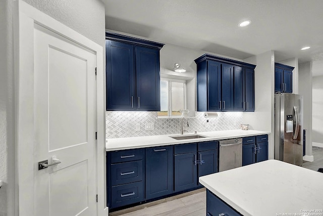 757 Joy, Floresville, TX 78114 - kitchen featuring appliances with stainless steel finishes, a sink, blue cabinetry, and recessed lighting