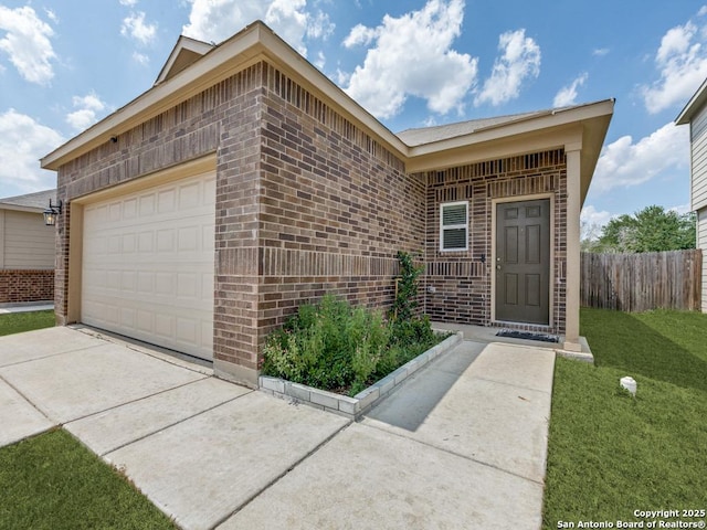 607 Pleasanton Spg, San Antonio, TX 78221 - property entrance with brick siding, an attached garage, and concrete driveway