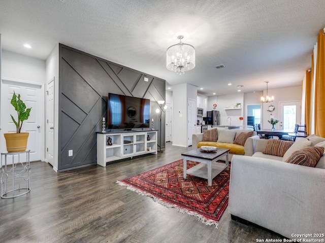 607 Pleasanton Spg, San Antonio, TX 78221 - living area with a chandelier, dark wood-type flooring, recessed lighting, a textured ceiling, and baseboards