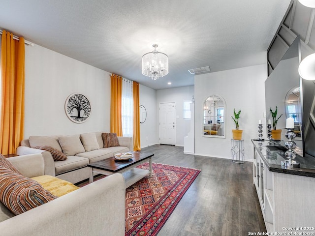 607 Pleasanton Spg, San Antonio, TX 78221 - living room featuring a chandelier, dark wood finished floors, and baseboards