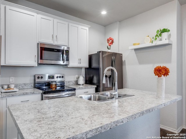 607 Pleasanton Spg, San Antonio, TX 78221 - kitchen with stainless steel appliances, a sink, white cabinetry, light countertops, and recessed lighting