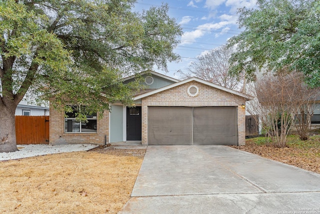 4543 Stradford, San Antonio, TX 78217 - view of front facade featuring brick siding, an attached garage, and driveway