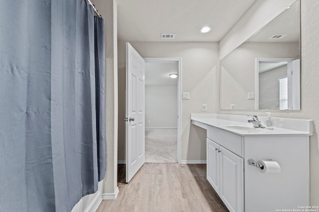 7115 Mesa Clfs, Converse, TX 78109 - bathroom featuring wood finished floors, vanity, and shower / bath combo with shower curtain