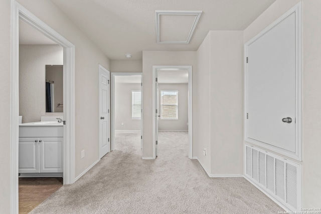 7115 Mesa Clfs, Converse, TX 78109 - hallway with carpet flooring, baseboards, and a sink