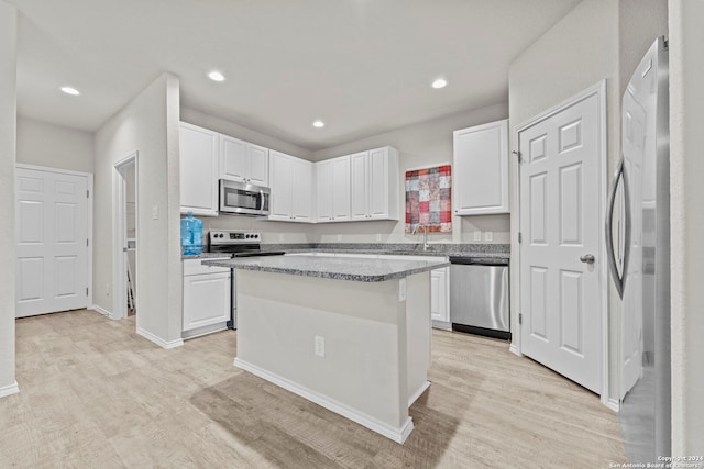 7115 Mesa Clfs, Converse, TX 78109 - kitchen featuring appliances with stainless steel finishes, light wood-style floors, white cabinets, and recessed lighting