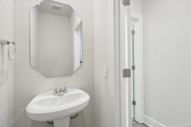 11554 Cottage Pt, San Antonio, TX 78254 - bathroom with a sink and a textured wall