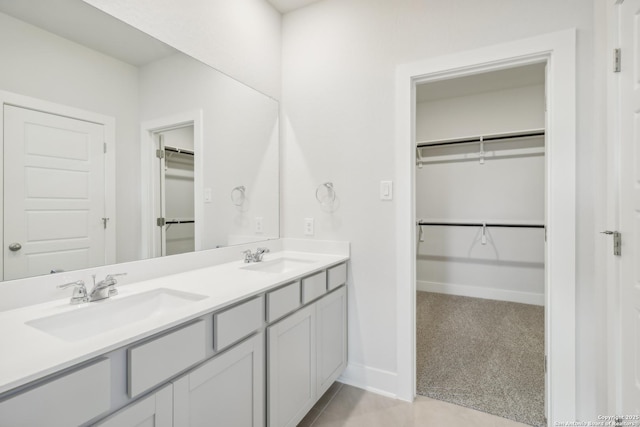 11554 Cottage Pt, San Antonio, TX 78254 - full bathroom with double vanity, a spacious closet, baseboards, and tile patterned flooring