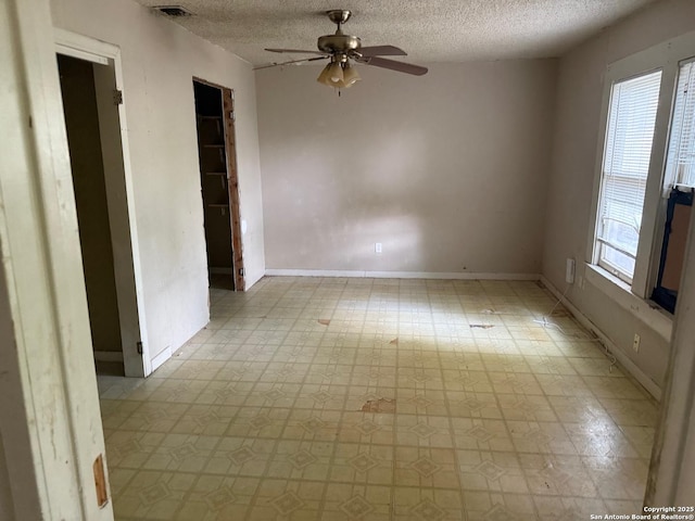 924 Santa Monica, San Antonio, TX 78201 - spare room featuring a textured ceiling, ceiling fan, light flooring, and baseboards