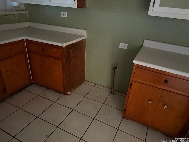 924 Santa Monica, San Antonio, TX 78201 - kitchen with light countertops, brown cabinetry, and light tile patterned flooring
